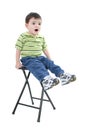 Adorable Boy Sitting On Stool With Upset Expression Royalty Free Stock Photo