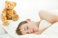 Adorable boy sleeping with plush bear Royalty Free Stock Photo