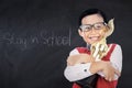 Adorable boy with trophy in class Royalty Free Stock Photo