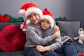 Adorable boys hugging each other celebrating christmas at home