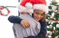 Adorable boys hugging each other celebrating christmas at home