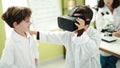 Adorable boys scientist student using virtual reality glasses at laboratory classroom