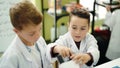 Adorable boys students using microscope at laboratory classroom Royalty Free Stock Photo