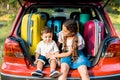 adorable brother and sister sitting near travel bags Royalty Free Stock Photo