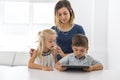 Adorable brother and sister young child using tablet with mother Royalty Free Stock Photo