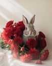 Adorable Bunny Rabbit Hiding in Red Flowers. Royalty Free Stock Photo