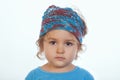 Adorable calm girl looking at camera and wearing blue handmade headband