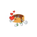 An adorable cartoon design of chocolate cream pancake holding heart Royalty Free Stock Photo