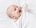 Adorable caucasian baby lying on bed smiling at bedroom Royalty Free Stock Photo