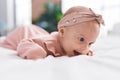 Adorable caucasian baby lying on bed smiling at bedroom Royalty Free Stock Photo