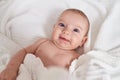 Adorable caucasian baby smiling confident lying on bed at bedroom Royalty Free Stock Photo