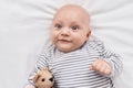 Adorable caucasian baby smiling confident lying on bed with teddy bear at bedroom Royalty Free Stock Photo