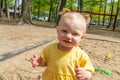 Adorable caucasian blond toddler at the public park