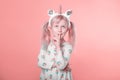 Adorable Caucasian blonde girl in white dress wearing unicorn headband horn and ears thinking dreaming Royalty Free Stock Photo