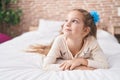 Adorable caucasian girl smiling confident lying on bed at bedroom Royalty Free Stock Photo