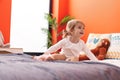 Adorable caucasian girl smiling confident sitting on bed at bedroom Royalty Free Stock Photo