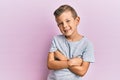 Adorable caucasian kid wearing casual clothes happy face smiling with crossed arms looking at the camera Royalty Free Stock Photo