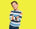 Adorable caucasian kid wearing casual clothes happy face smiling with crossed arms looking at the camera Royalty Free Stock Photo