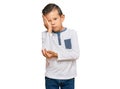 Adorable caucasian kid wearing casual clothes thinking looking tired and bored with depression problems with crossed arms Royalty Free Stock Photo