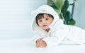 Adorable caucasian little baby daughter girl, wearing cute white bathrobe, taking bath in morning, crawling on floor with copy Royalty Free Stock Photo