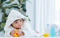 Adorable caucasian little baby daughter girl, wearing cute white bathrobe, taking bath in morning, crawling on floor with copy Royalty Free Stock Photo