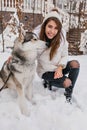 Adorable caucasian woman spending time outdoor enjoying frosty weather with her pet. Photo of pretty young lady in Royalty Free Stock Photo