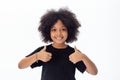 Adorable and cheerful African American kid with afro hairstyle giving thumbs up Royalty Free Stock Photo