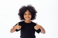 Adorable and cheerful African American kid with afro hairstyle giving thumbs up Royalty Free Stock Photo