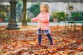 Adorable cheerful toddler girl running in Tuileries garden in Paris, France Royalty Free Stock Photo