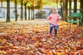 Adorable cheerful toddler girl running in Tuileries garden in Paris, France Royalty Free Stock Photo