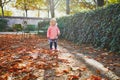 Adorable cheerful toddler girl running in Tuileries garden in Paris Royalty Free Stock Photo
