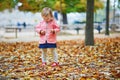 Adorable cheerful toddler girl running in Tuileries garden in Paris Royalty Free Stock Photo