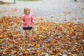 Adorable cheerful toddler girl running in Tuileries garden in Paris Royalty Free Stock Photo