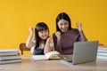 An adorable and cheerful young Asian girl enjoys studying an online lesson with her private tutor Royalty Free Stock Photo