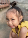 Adorable child Asian woman playing outdoor, happy cute little girl with funny face and looking to camera. Royalty Free Stock Photo