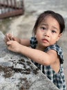 Adorable child Asian woman playing outdoor and looking at camera, happy cute little girl with muddy hands Royalty Free Stock Photo