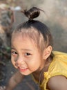 Adorable child Asian woman smiling and playing outdoor, happy cute little girl with big smiling and looking to camera. Royalty Free Stock Photo