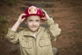 Adorable Child Boy with Fireman Hat Playing Outside Royalty Free Stock Photo