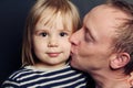 Adorable child and father. Dad kissing her baby, loving family Royalty Free Stock Photo