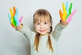 Adorable child girl with colorful painted hands on white background Royalty Free Stock Photo