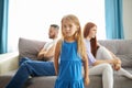 Adorable child girl between depressed offended on each other parents Royalty Free Stock Photo