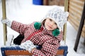 Adorable child girl enjoys seesaw in winter