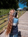 Adorable child girl with long hair chatting in social media smartphone talking on video call reading book outdoor Royalty Free Stock Photo