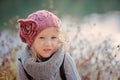 Adorable child girl in pink knitted hat and grey sweater close up portrait Royalty Free Stock Photo