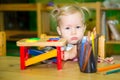 Adorable child girl playing with educational toys in nursery room. Kid in kindergarten in Montessori preschool class. Royalty Free Stock Photo