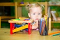 Adorable child girl playing with educational toys in nursery room. Kid in kindergarten in Montessori preschool class. Royalty Free Stock Photo