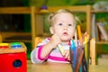 Adorable child girl playing with educational toys in nursery room. Kid in kindergarten in Montessori preschool class. Royalty Free Stock Photo