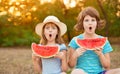 Adorable child girls with wonder face and with watermelon in hands think about question, thoughtful about confusing idea Royalty Free Stock Photo