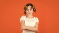 Adorable child hairdo. Female beauty routine. Styling tips. Teen hobbies. Small girl Curling Hair Using Curlers orange Royalty Free Stock Photo