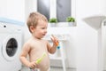 Adorable child learing how to brush his teeth